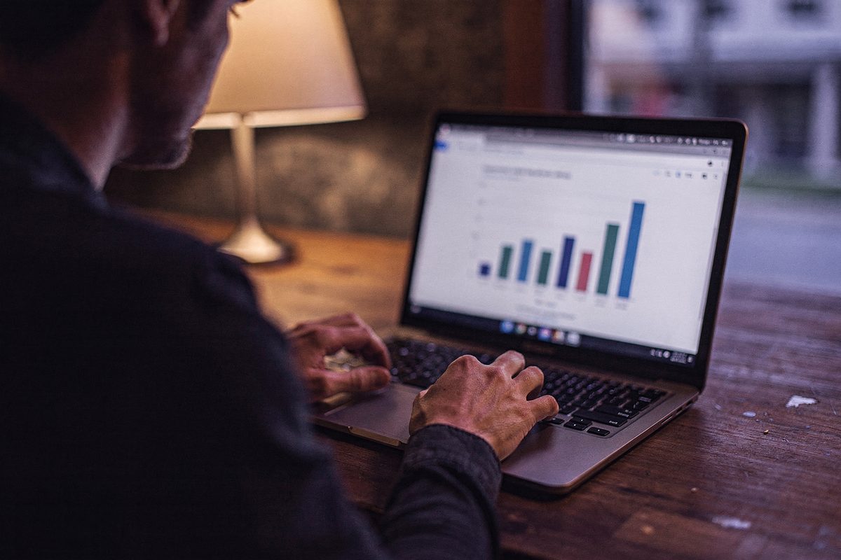 Hands on a laptop reviewing a chart during a pricing review